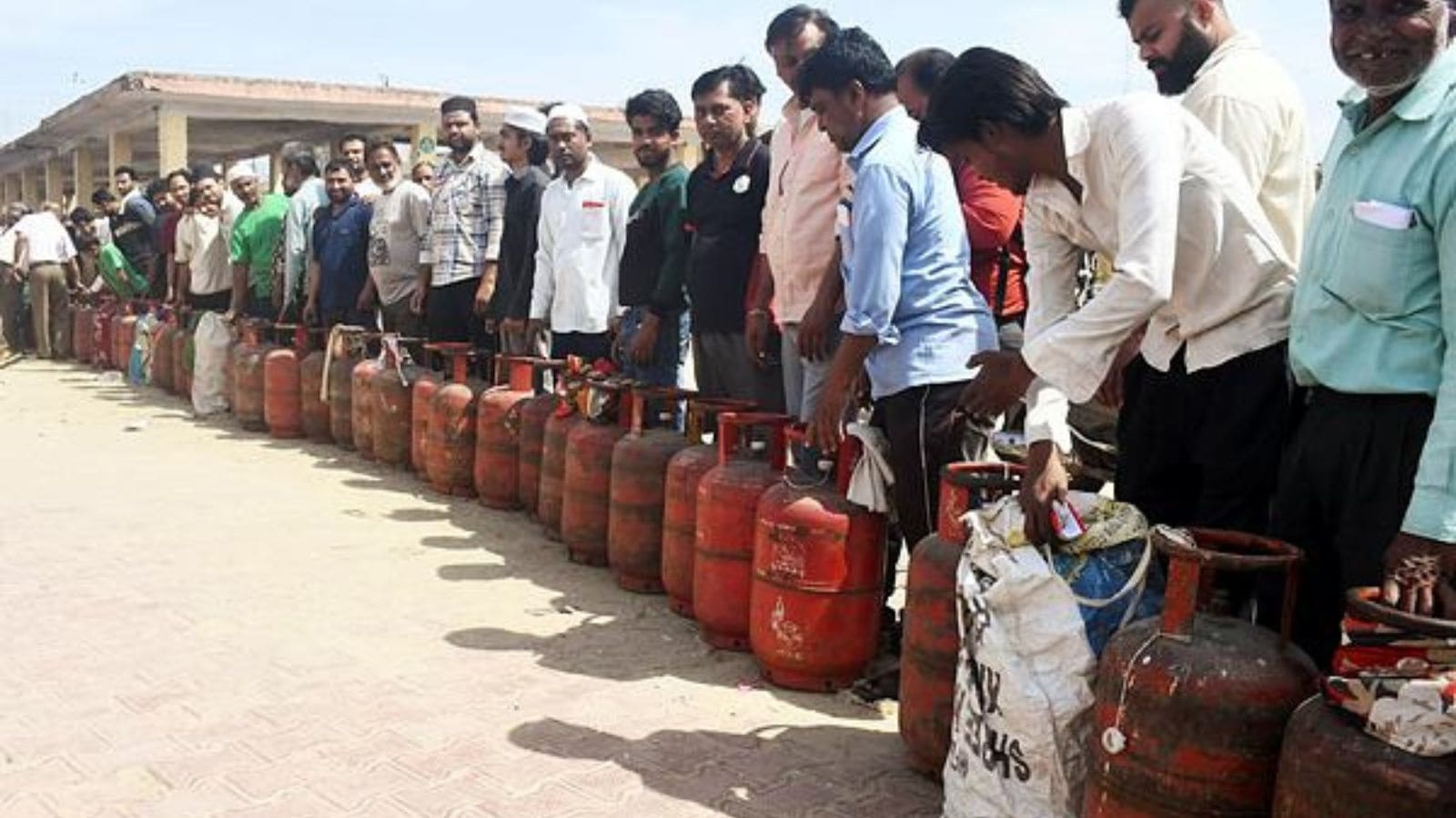 People stand in a queue with their LPG cylinders amid the reports of a nationwide shortage of LPG gas cylinders. (ANI Photo)