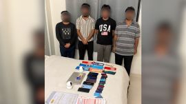 the four accused caught at the villa with the items seized from them.