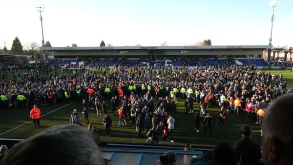 Macclesfield FC's fans and players celebrate on the pitch after defeating Crystal Palace in the 3rd round of the FA Cup. (PHOTO: Reuters)