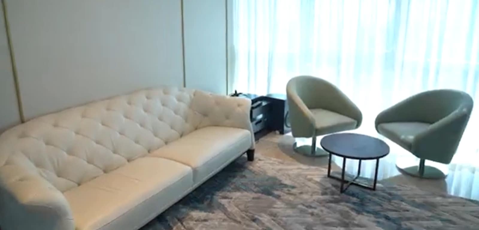 The living area is expansive and airy, benefiting from natural light that pours in from the large windows overlooking the sea.