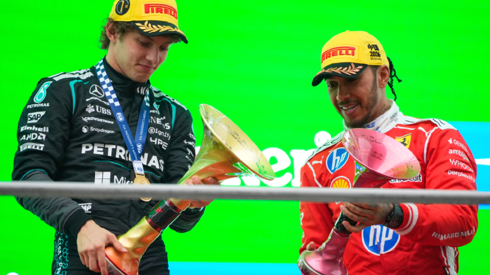 Race winner Mercedes driver Andrea Kimi Antonelli of Italy, left, celebrates on the podium with third placed Ferrari driver Lewis Hamilton of Britain after the Chinese Formula One Grand Prix race at the Shanghai International Circuit, in Shanghai, China, Sunday, March 15, 2026. (AP Photo)