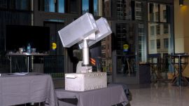 A high-energy laser called Archimedes developed by Aurelius Systems, on display during Reindustrialize, a manufacturing conference in Detroit, July 17, 2025. High-energy lasers that the US is using to counter drone attacks can burn them in the sky like a blowtorch, but they can be stymied by weather and making them at scale will be a challenge. (Credits: Nic Antaya)