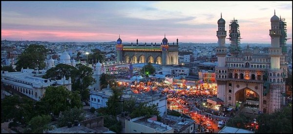 A stunning panorama of Charminar and its surroundings, featuring the vibrant Charminar Bazar, the historic Mekkah Masjid, the renowned Nizamia Unani Hospital, and the colorful Laad Bazaar.(Source: Wikimedia Commons) 