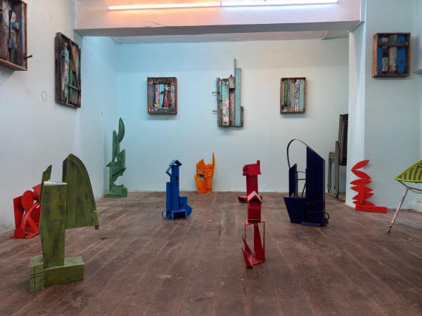 The upper loft features sculptural works by Bhushan Bhombhale, using primary colours and found materials to explore form and everyday life. 