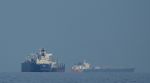 Oil tankers and cargo ships line up in the Strait of Hormuz as seen from Mina Al Fajer, United Arab Emirates, Wednesday, March 11, 2026. (AP Photo)