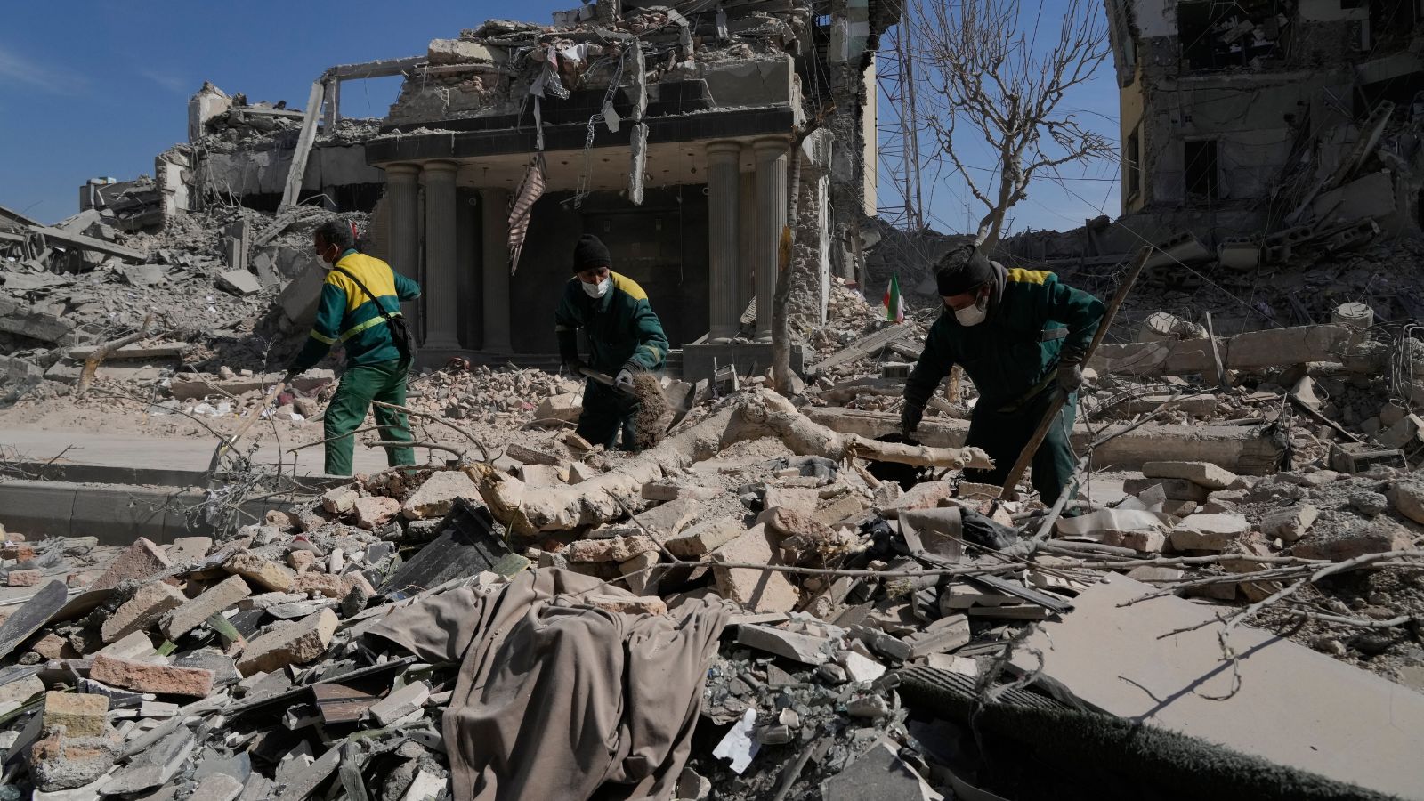 Workers remove the rubble of a police facility struck during the U.S.–Israeli military campaign in Tehran, Iran, Wednesday, March 4, 2026. (AP Photo)