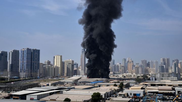 A black plume of smoke rises from a warehouse at the industrial area of Sharjah City in the United Arab Emirates following reports of Iranian strikes in Dubai. (AP Photo)