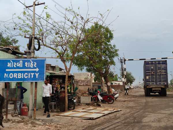 A truck carrying a shipping container outside Morbi city. (Express Photo) 