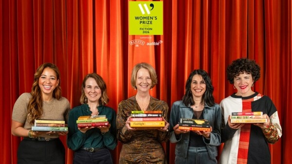 The judges holding the 16 books that make up the 2026 Women’s Prize for Fiction longlist. 