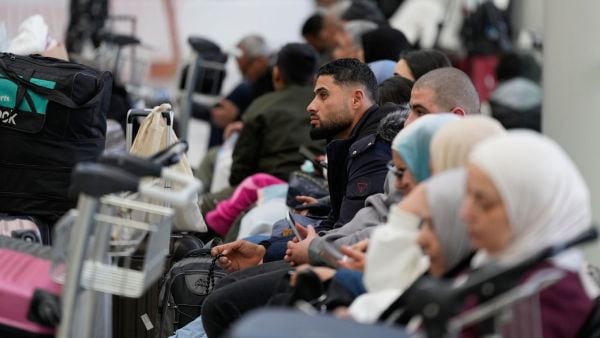 Passengers whose flights were cancelled, wait at the departure terminal of Rafik Hariri International Airport in Beirut, Lebanon (AP Photo)