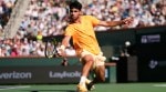 Carlos Alcaraz returns a shot against Daniil Medvedev during a semifinal match at the BNP Paribas Open tennis tournament, Saturday, March 14, 2026, in Indian Wells, Calif. (AP Photo)