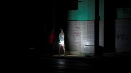 People walk on a street during a blackout in Havana, Cuba, Saturday, March 21, 2026. (AP Photo/Ramon Espinosa)