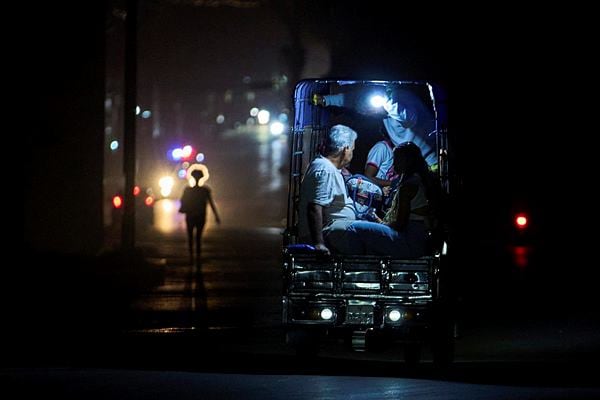 An electric tricycle transports customers during a blackout in Havana, Cuba, Saturday, March 21, 2026. (AP Photo/Ramon Espinosa)