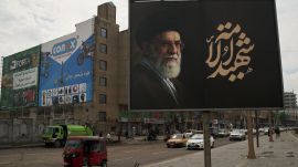 A sign displays an image depicting the late Iranian Supreme Leader Ayatollah Ali Khamenei with the words in Arabic "Martyr of God", on a street in Baghdad, Iraq, Wednesday, March 25, 2026. (AP Photo/Leo Correa)