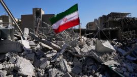 An Iranian flag is placed among the ruins of a police station struck Monday during the U.S.–Israeli military campaign in Tehran, Iran, Tuesday, March 3, 2026. (AP Photo)