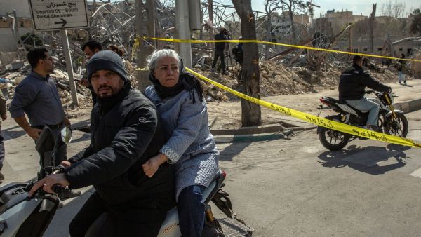 A photograph taken during a government-led press tour shows passersby in Tehran on Wednesday, March 4, 2026, inspecting the remains of a police station that was destroyed by a US-Israeli airstrike. The conflict in Iran may give Moscow a short-term economic boost and in Ukraine, but it has also demonstrated the limits of Russia's partnerships. (Credit: Arash Khamooshi/The New York Times)