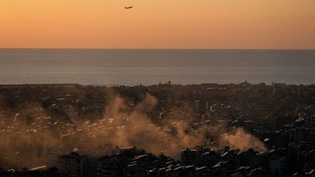 A plane takes off from the Beirut–Rafic Hariri International Airport as smoke from an earlier Israeli airstrike still rises in Dahiyeh, Beirut's southern suburbs, Lebanon, Thursday, March 5, 2026.(AP Photo/Hussein Malla)