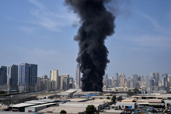 A black plume of smoke rises from a warehouse at the industrial area of Sharjah City in the United Arab Emirates following reports of Iranian strikes in Dubai, United Arab Emirates, Sunday, March 1, 2026.AP/PTI(AP03_01_2026_000731B)