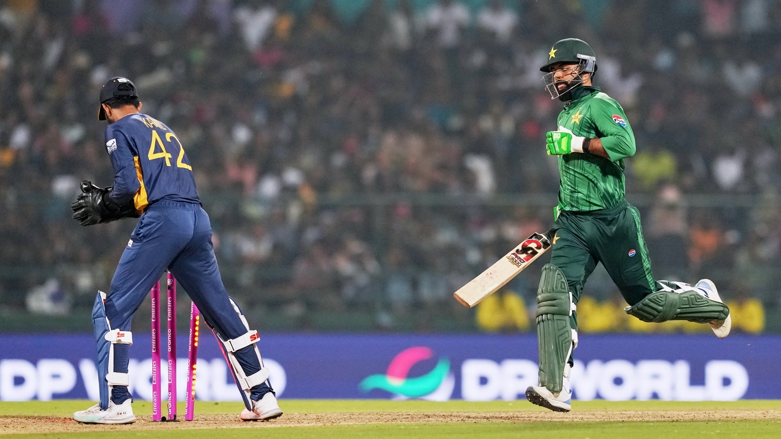 Pakistan's Shadab Khan, right, is run out by Sri Lanka's Kamil Mishara during the T20 World Cup cricket match between Pakistan and Sri Lanka in Pallekele, Sri Lanka, Saturday, Feb. 28, 2026. (AP Photo/Eranga Jayawardena)