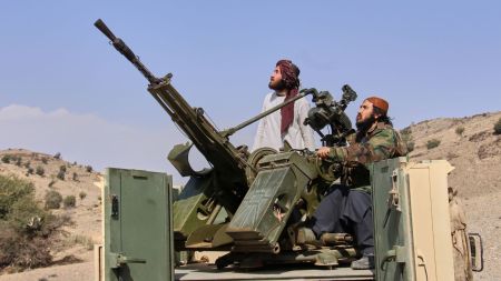 Taliban fighters look up while manning an armed pickup truck at the Afghan side of the Ghulam Khan crossing with Pakistan in Khost province, Afghanistan, Friday, Feb. 27, 2026. AP/PTI(AP02_27_2026_000167B)