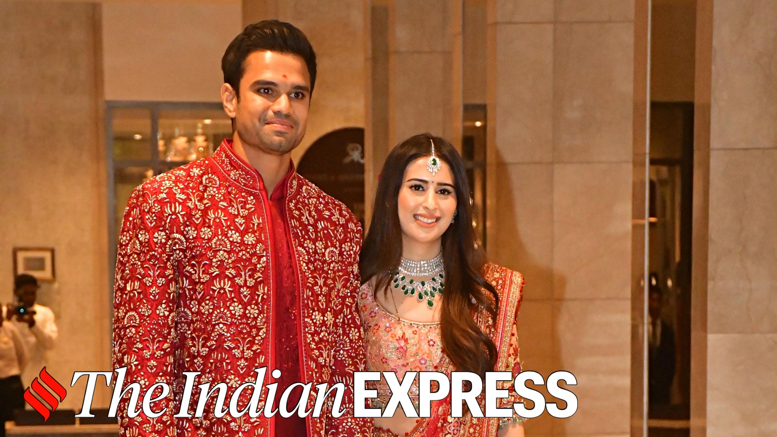 Arjun Tendulkar’s red sherwani perfectly complements Saaniya Chandhok’s red zari bridal sari as the couple ties the knot