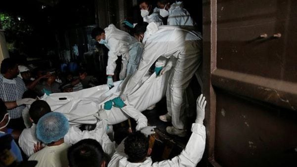 Healthcare workers unload the bodies of Iranian sailors in Galle, Sri Lanka (AP Photo)