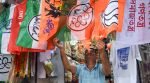 A vendor arranges various political parties' flags for sale for the upcoming West Bengal Assembly elections, in Kolkata on Sunday. (ANI Photo)