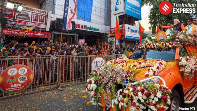 As the campaign vehicle moved slowly along the route, Modi waved at supporters while people showered flowers