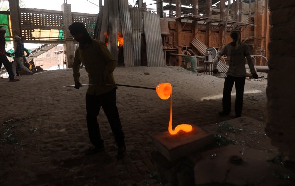  All beautiful chooris begin with the melting of raw glass. Once the glass reaches the consistency of honey, a worker uses a metal rod to extract a glob and, as the molten substance cools.  Express Photo by Gajendra Yadav