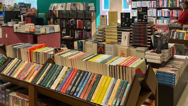 A store with books stacked on shelves 
