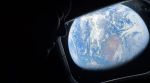 Earth seen through the Orion spacecraft window as an Artemis II crew member looks on during the return journey. (Image: Nasa)