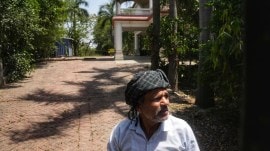 Along a shiny new expressway, a sole house and its lone caretaker are the face of an old fight