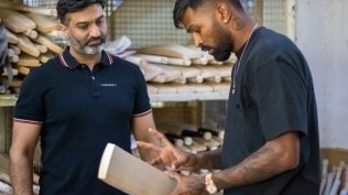 All-rounder Hardik Pandya (R) inspects his bat with SG's Paras Anand in Meerut. (Special arrangement)