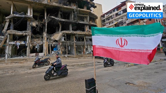 A man on his scooter passes next to an Iranian flag placed in front of a destroyed building, following a ceasefire between Hezbollah and Israel, in Dahiyeh, Beirut's southern suburbs, Lebanon, Monday, April 20, 2026. (AP Photo/Hussein Malla)