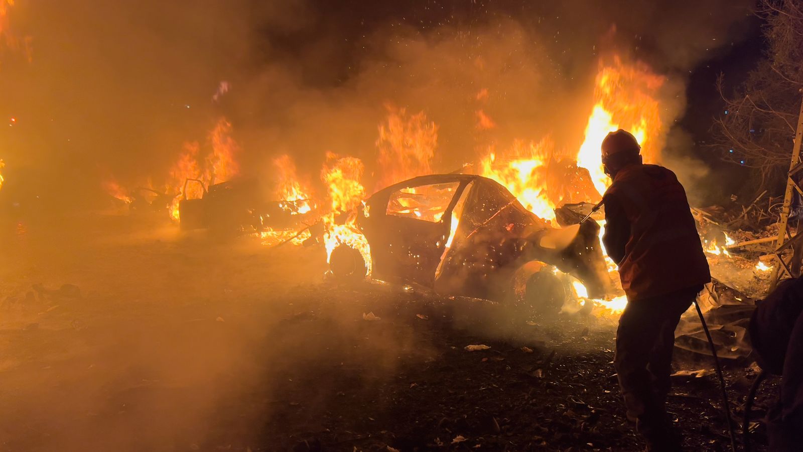 A firefighter extinguishes a car at the site of Israeli airstrikes, in Beirut, Lebanon. (AP Photo)