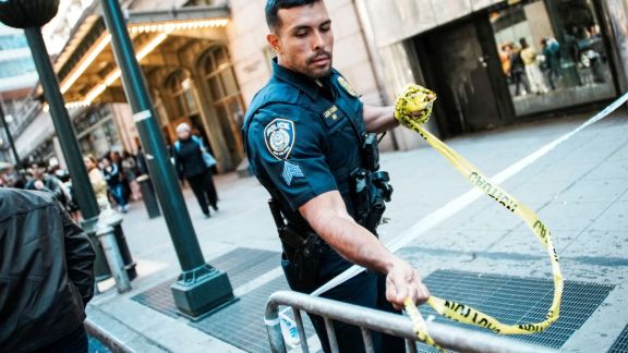 An NYPD officer removes police tape outside Grand Central subway station in New York City on April 11. (Reuters)