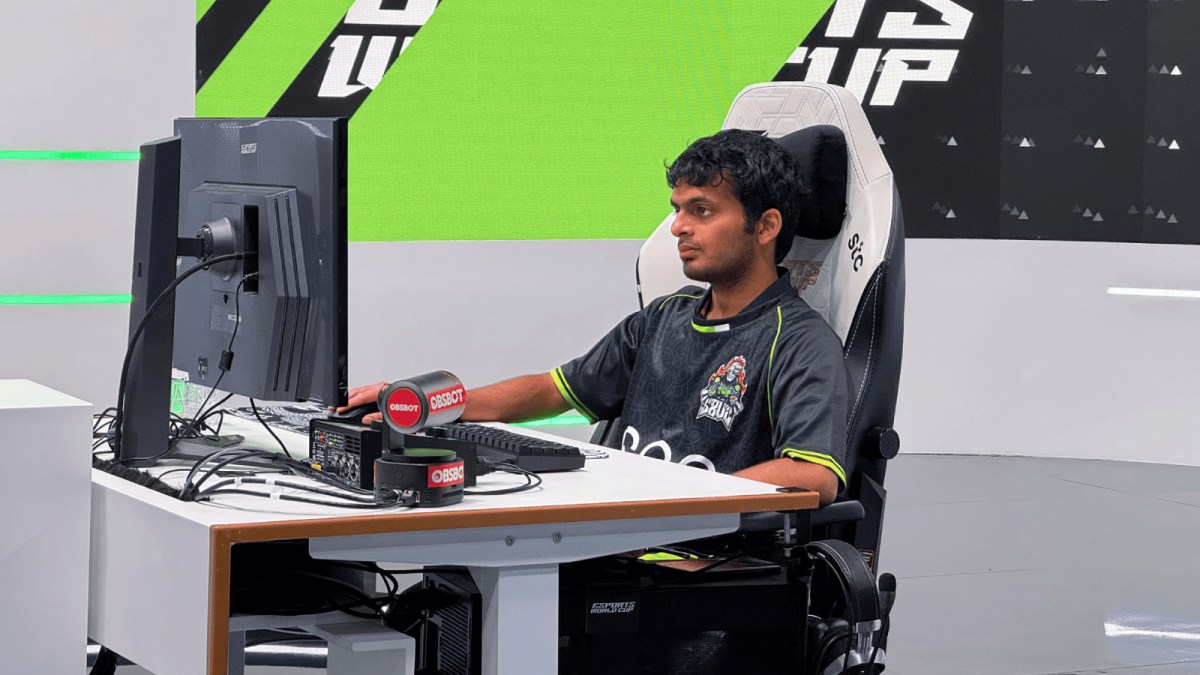Indian chess grandmaster Nihal Sarin playing at a gaming desk in an S8UL Esports jersey.
