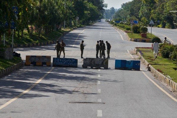 Police officers stand guard at a barricaded road to ensure security ahead of the United States and Iran possible negotiations in the Pakistani capital, Islamabad. (AP Photo)