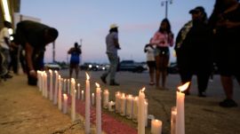 A man lights a candle during a prayer vigil for the victims of a mass shooting earlier in the day, Sunday, April 19, 2026, in Shreveport, La. (AP Photo)