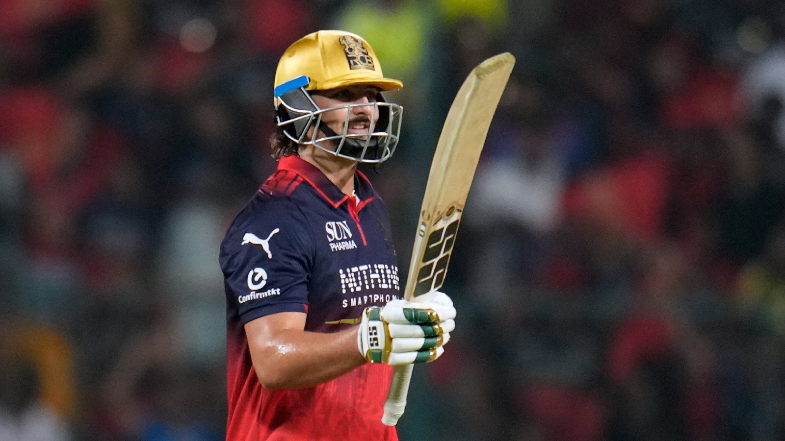 Royal Challengers Bengaluru's Tim David celebrates his fifty runs during the Indian Premier League cricket match between Chennai Super Kings and Royal Challengers Bengaluru in Bengaluru, India, Sunday, April 5, 2026. (AP Photo)
