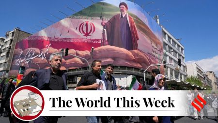 Government supporters walk past a billboard depicting Iran's Supreme Leader, Mojtaba Khamenei, as they gather to mark the 40th day since the killing of his father, Ayatollah Ali Khamenei, in Tehran. (AP Photo)