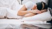 A woman slepping with eye mask on.