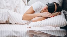 A woman slepping with eye mask on.