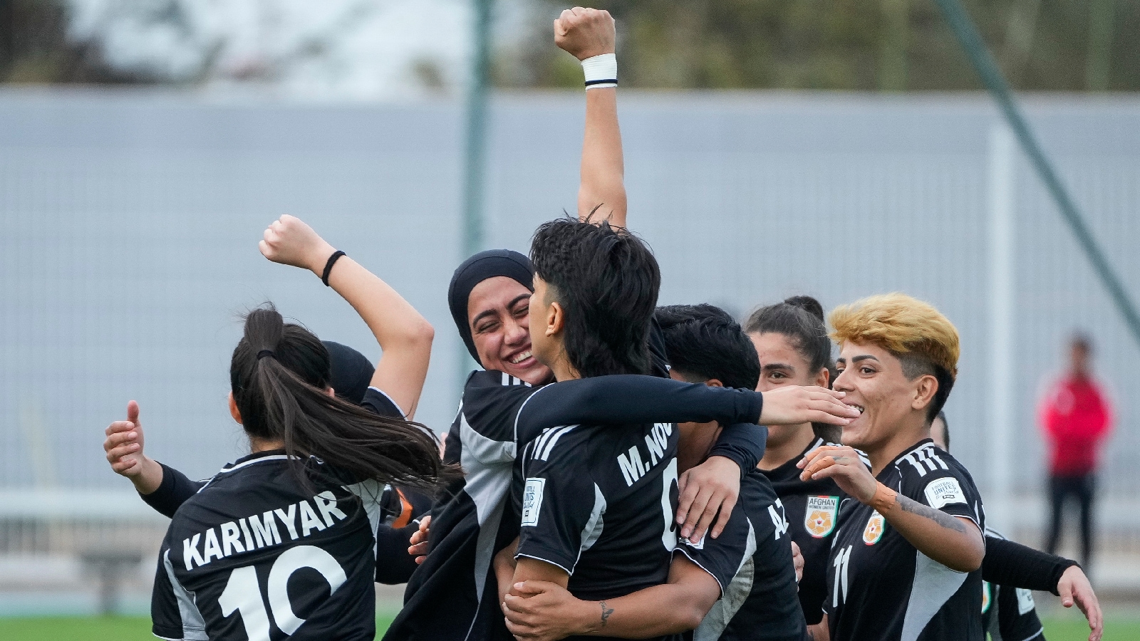 Members of the Afghan Women United football team celebrate after scoring a goal against Chad, in their first international tournament since fleeing their country in October 2025. (AP Photo)