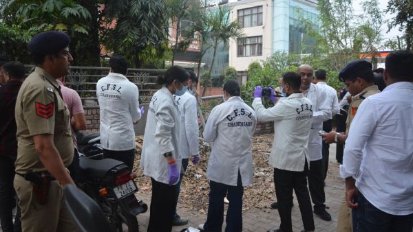 Chandigarh Police, along with a CFSL team, investigate the site following a blast outside the Punjab BJP office in Sector 37, Chandigarh, on Wednesday. Express photo by Jasbir Malhi.