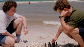 Magnus Carlsen and Hans Niemann play a game on the beach in Miami. Still from a scene in Untold: Chess Mates documentary. (Photo courtesy: Netflix)