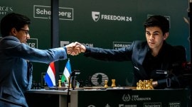 Javokhir Sindarov accepts Anish Giri's resignation at the Candidates. (Photo: Niki Riga / FIDE)