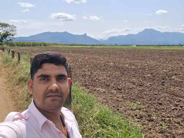 Yogesh Sharma, a chartered accountant from Haryana, who has acquired 160 acres of land in Morogoro, Tanzania, at his farm; his mother inspecting his fields