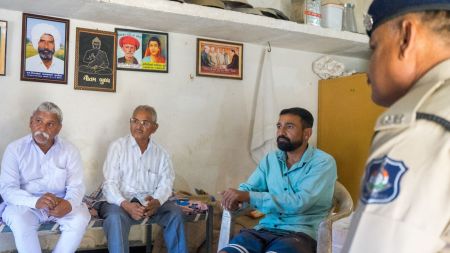Vashram Sarvaiya (second from right) along with his father Balu Sarvaiya (first from left), a guest and a policeman (first from right) at their home in Mota Samadhiyala village. Express photo by Bhupendra Rana