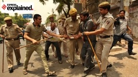 Police detain a student during a protest outside the RSS HQ over CSAT in the Civil Services Exam in New Delhi in 2014.
